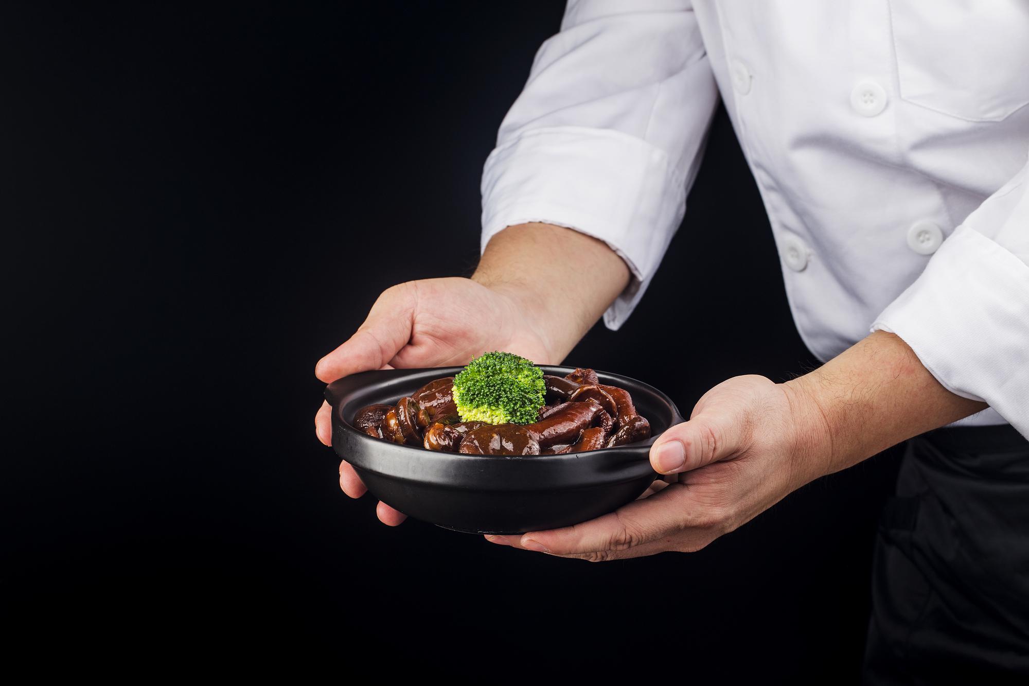 chef plating a modern dish in a studio kitchen